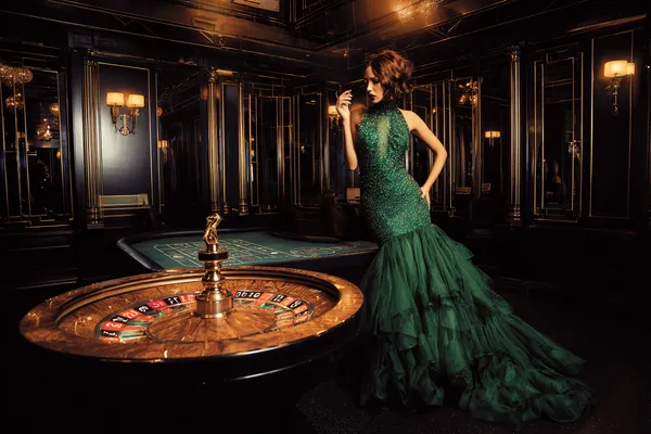 A man focused on his laptop with live stats in the background, highlighting the dedicated sports and gaming features of the TKPK mobile app.