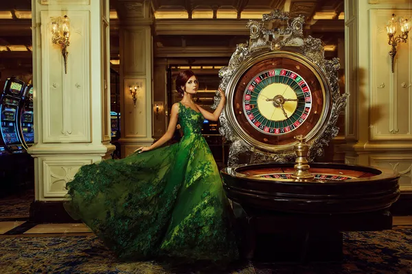 TKPK Casino Games — Enjoy nonstop entertainment A close-up shot of golden coins falling around a spinning roulette wheel, representing immersive casino action at TKPK.