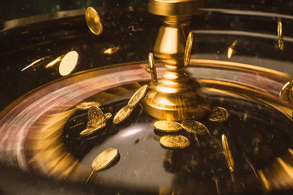 A woman smiling while playing online games on her laptop, surrounded by neon casino elements, showcasing TKPK’s diverse game collection.
