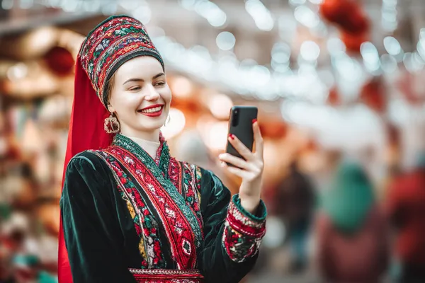 A man celebrating a winning moment on his laptop while gaming symbols float around him, capturing the excitement of TKPK games.